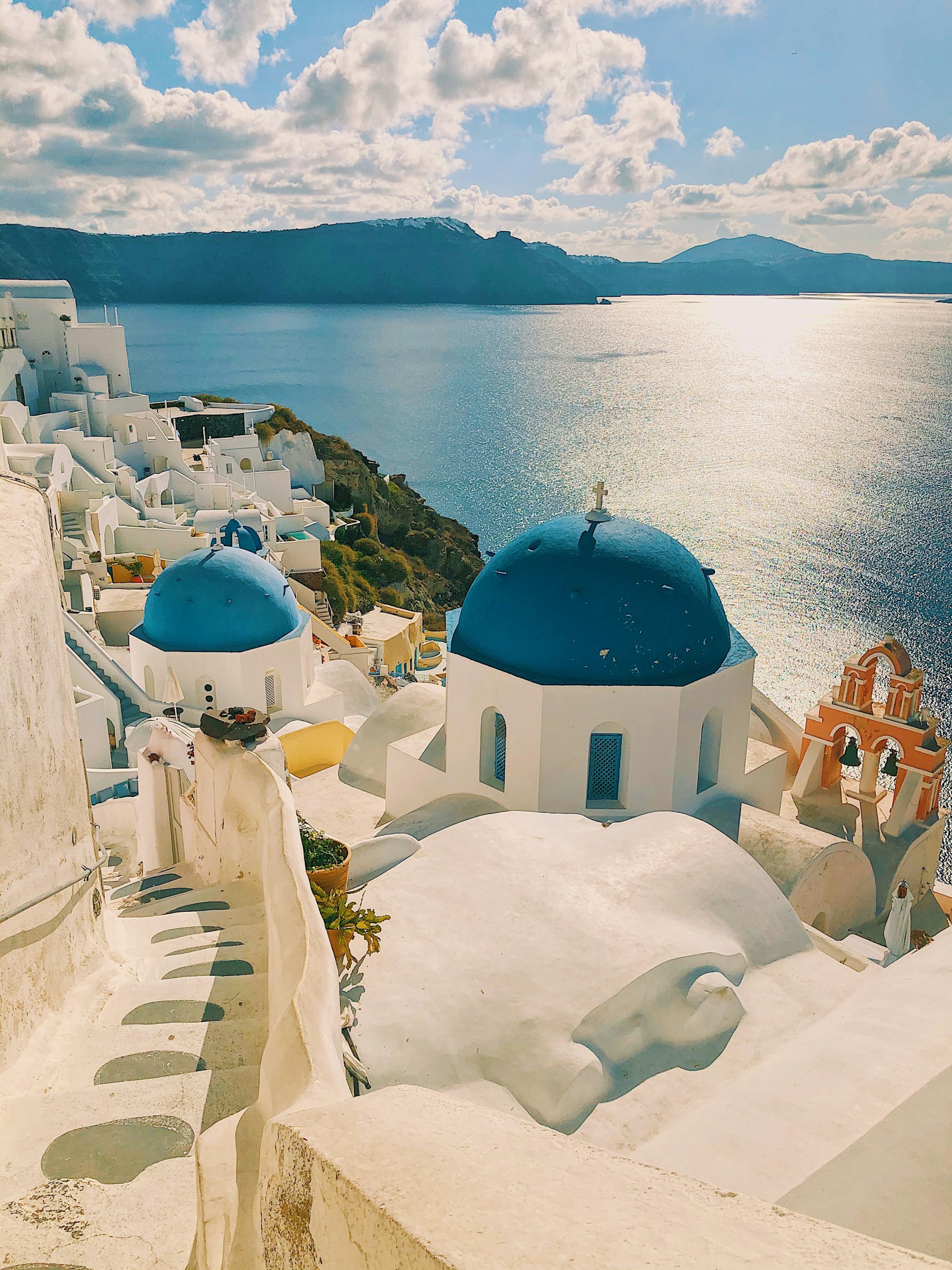 Whitewashed buildings and blue church domes overlooking the sea in Santorini